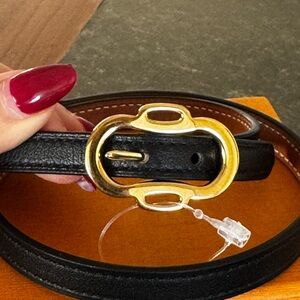 Hermès: a Black and Gold Swift Leather Boucleries Triple Tour Bracelet